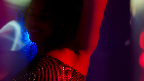 Close-Up-Of-Young-Woman-In-Nightclub-Bar-Or-Disco-Dancing-With-Sparkling-Lights-1